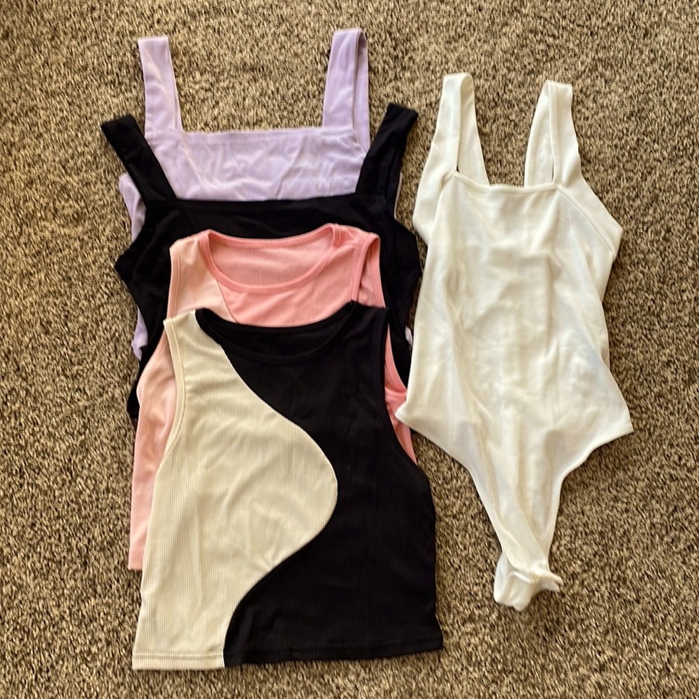NEW size large but runs more like medium, and a body suit size small.  Lot of 4